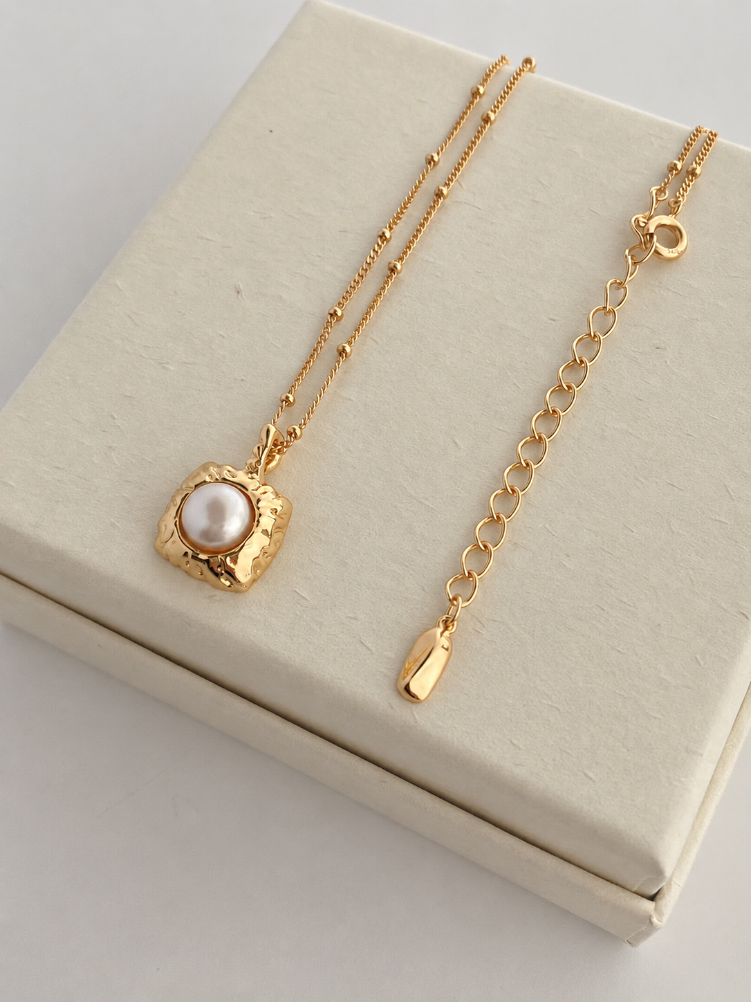 Hammered gold tag pendant with a freshwater pearl, on a beaded S925 silver chain. 40cm with extender.